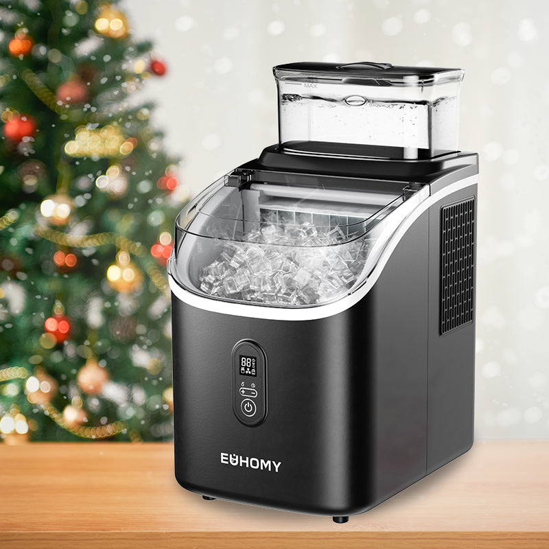 Black Euhomy Tile SE ice maker filled with ice cubes, festive Christmas tree bokeh background, holiday context.