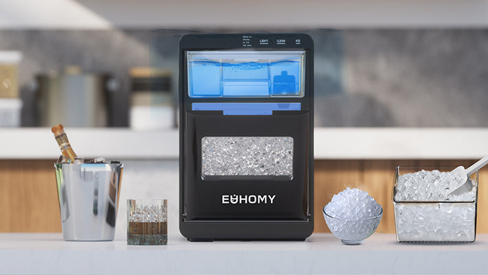 Euhomy ice maker producing fresh nugget ice for a glass of whiskey and serving bowls on a modern kitchen counter.